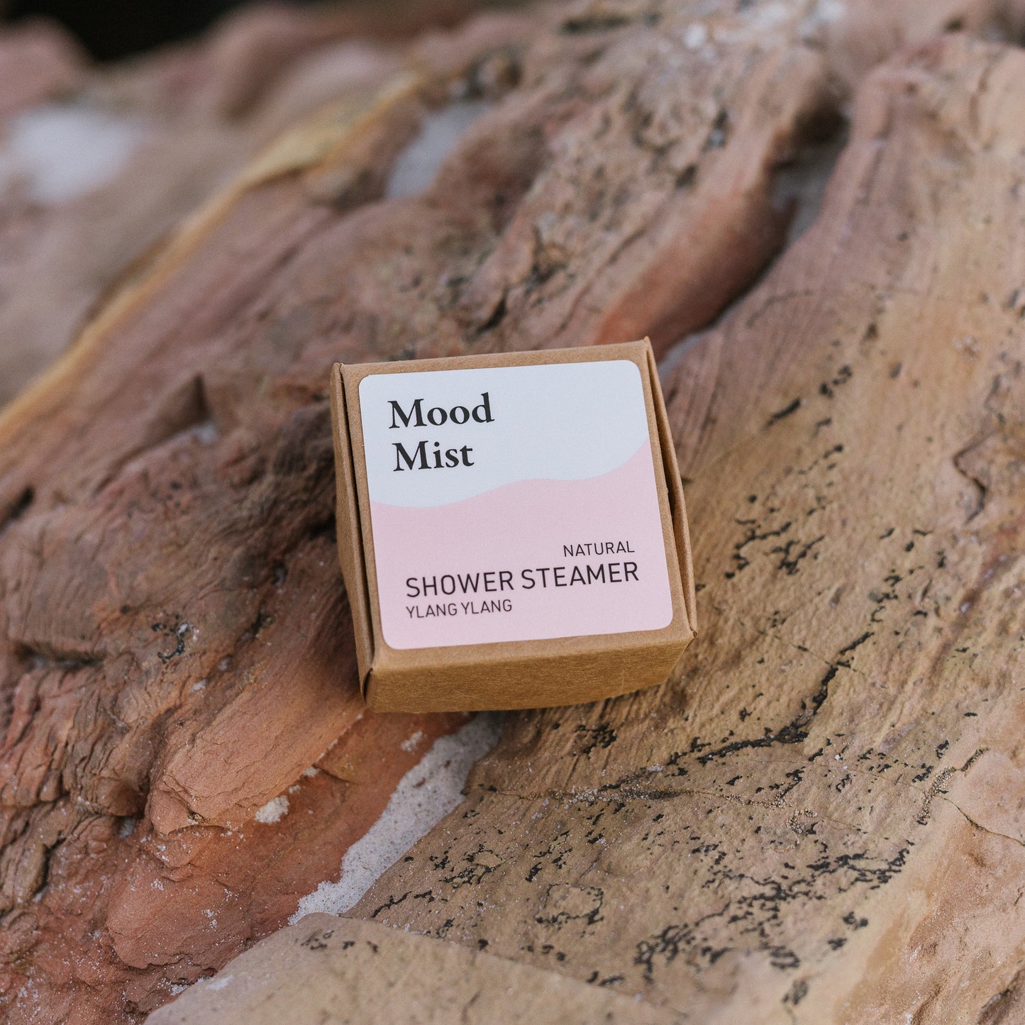Mood Mist natural shower steamer packaging on a wooden surface