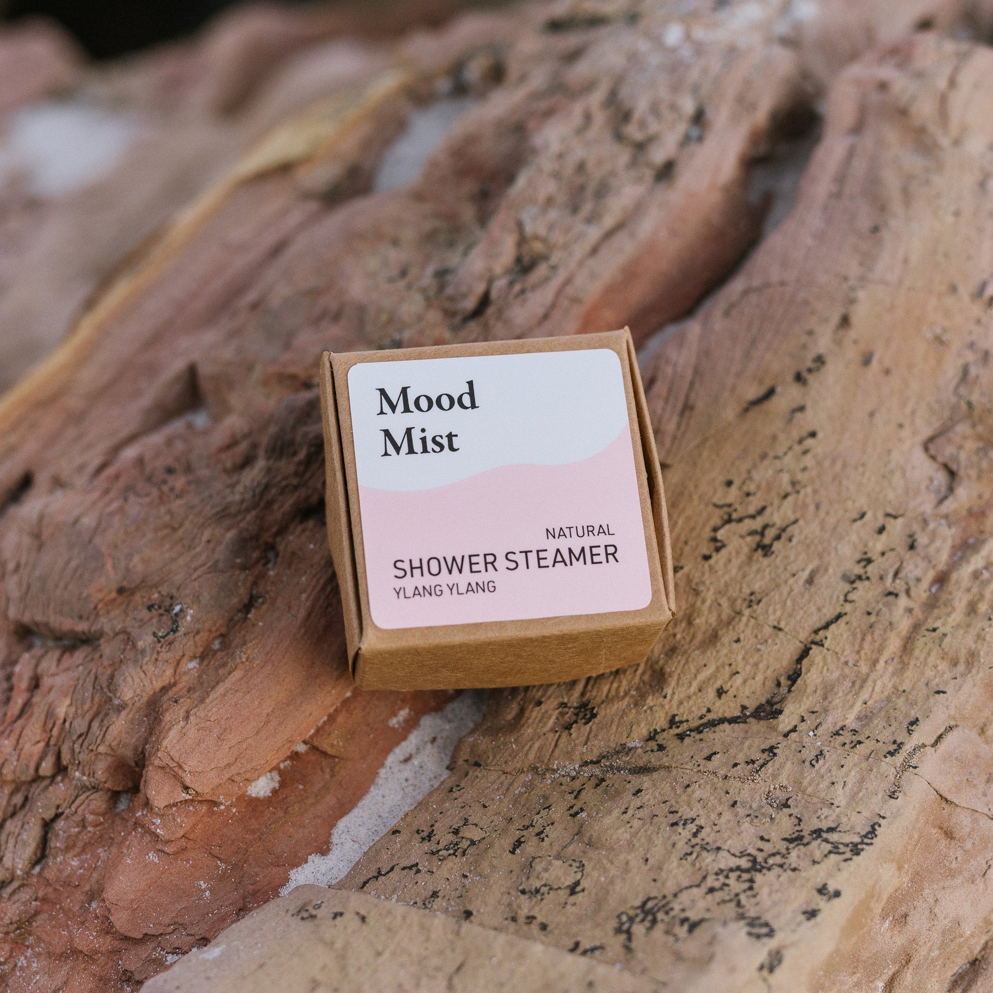 Mood Mist natural shower steamer packaging on a wooden surface